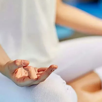 closeup of fingers holding meditation finger gesture