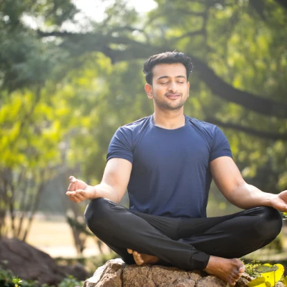 man sitting in forest meditating
