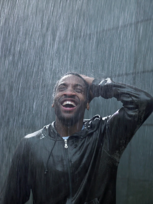 man laughing in rain