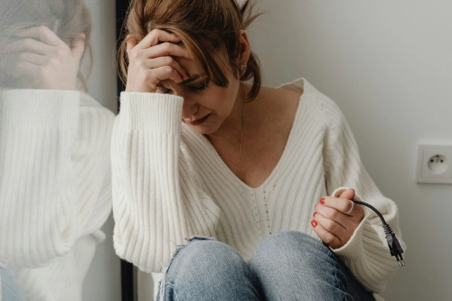 sad woman in corner