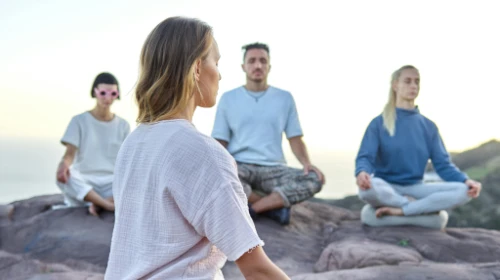 people meditating outside